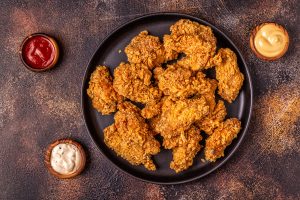Fried chicken wings with various sauces.