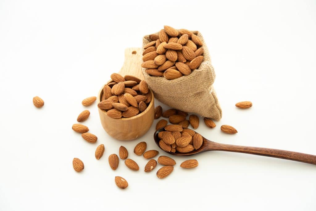 almond in a wooden spoon and bowl
