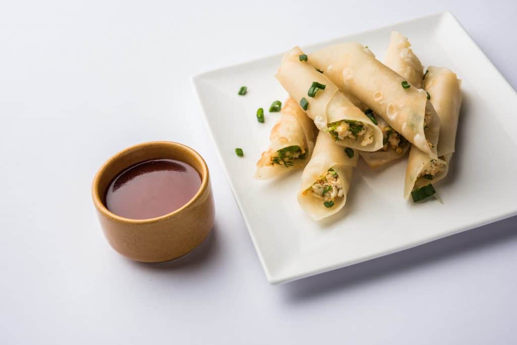 Paneer chilli cigar are crispy rolls stuffed with paneer which is an interesting starter for any party. served with tomato ketchup. selective focus