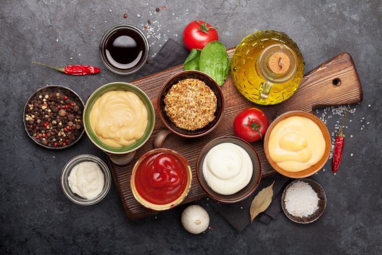 Set of various sauces. Popular sauces in bowls - ketchup, mustard, mayonnaise. Top view. Flat lay