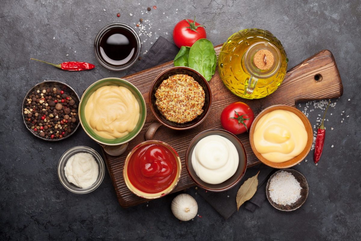 Set of various sauces. Popular sauces in bowls - ketchup, mustard, mayonnaise. Top view. Flat lay