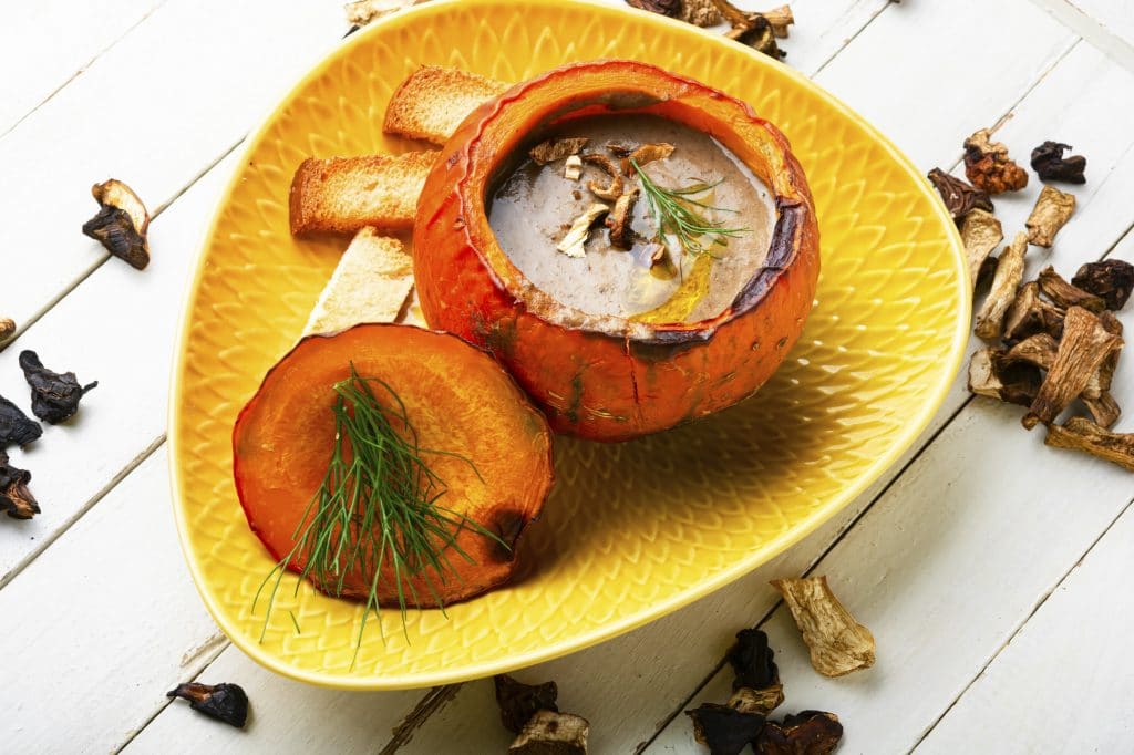 Homemade mushroom cream soup in pumpkin.Traditional autumn soup