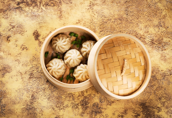 Chinese steamed dumplings in bamboo steamer, top view